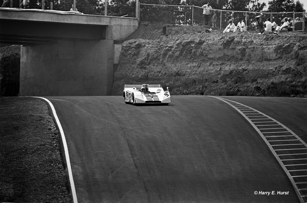 I think this photo, more than any I took, shows the major defining feature of Road Atlanta when it first opened in 1970 - the downhill drop into Turn 12, then going on the the front straight. Oscar Koveleski told me this was the part that "separated the men from the boys, especially in a Can-Am car!" Here, George Eaton takes his BRM P154 out of Turn 11 and drops off the face of the earth. I can't imagine the feeling in the pit of your stomach when you would do this. This photo also shows the minimal runoff some areas of the course had, with an imposing red clay wall waiting. Revson would hit the wall up in the left hand corner of the frame during the race when a tire blew. Photo and info Harry E. Hurst